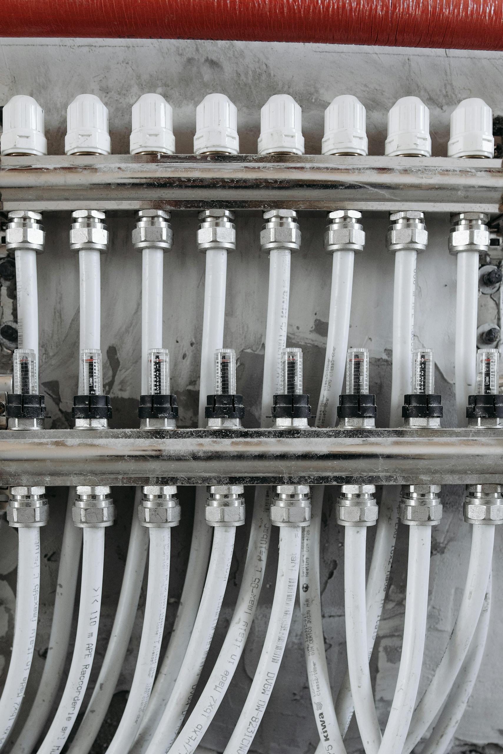 Close-up view of an industrial pipe connection system with gauges and valves.